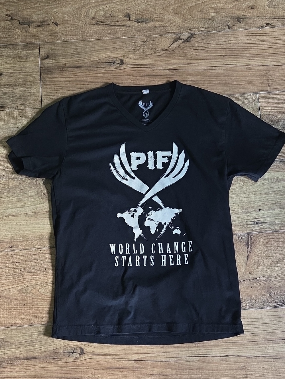 Next Level Apparel | Black V-Neck Tee with White World Change Graphic